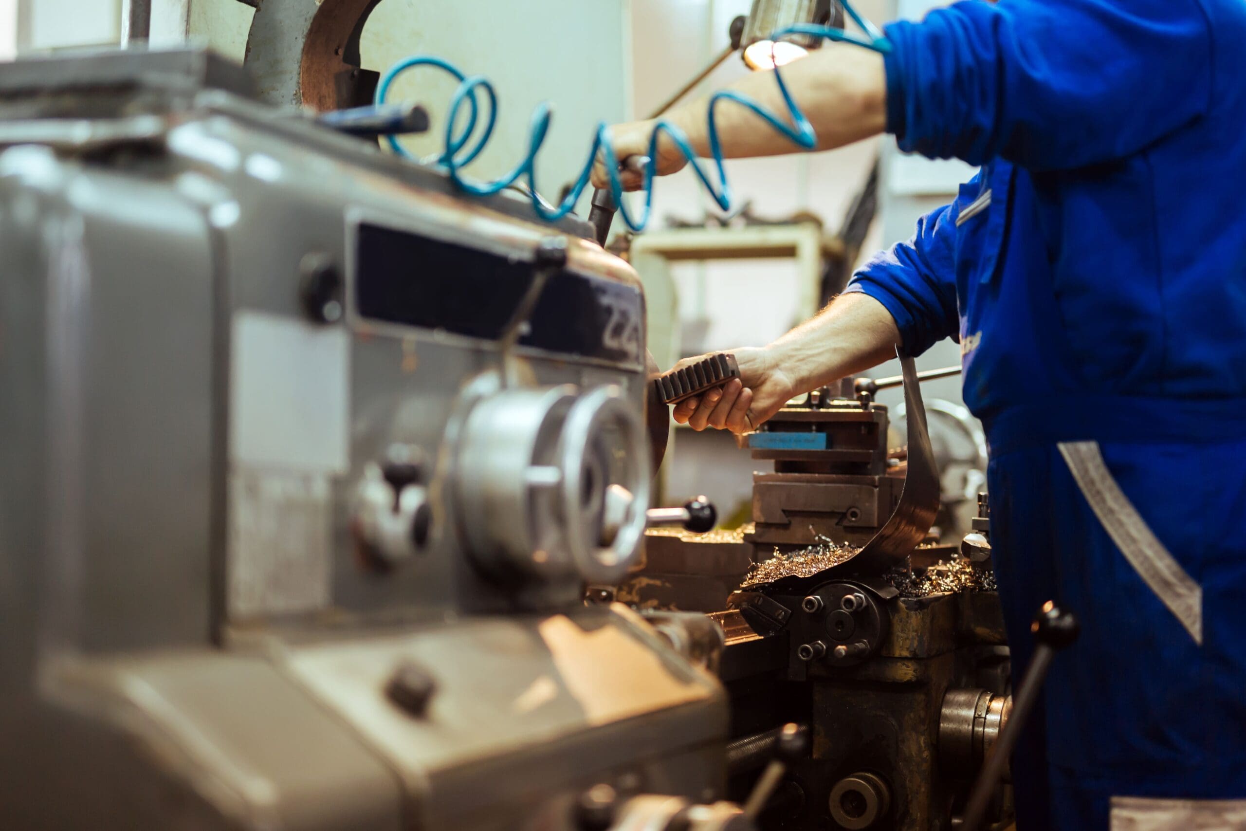 Machine operator running a lathe.