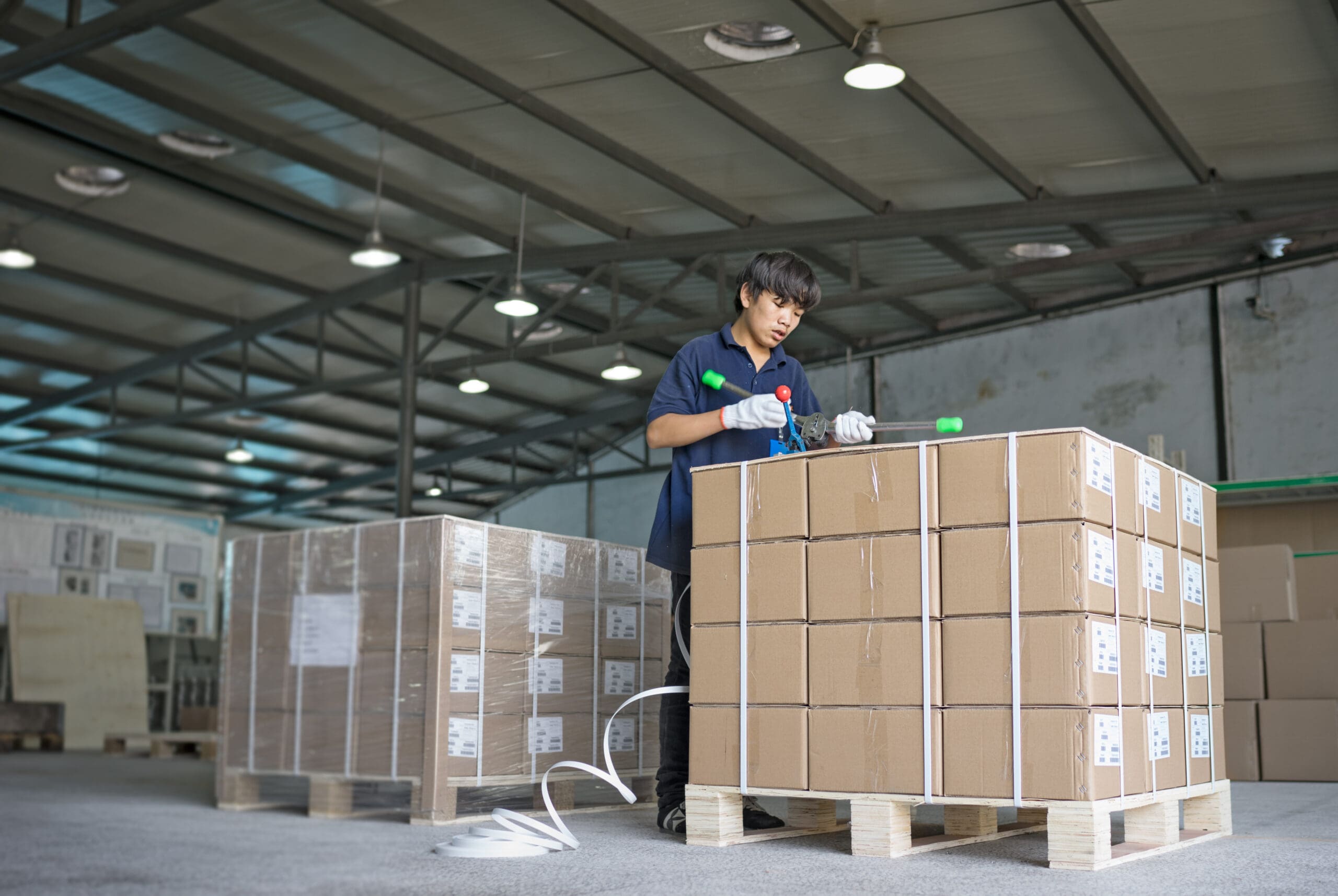 Man preparing packages and palletized products for shipment to Seglian's customers.